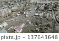 Spring flood disaster with fully submerged houses, flooded roads and overflowing waterways. The footage shows the dramatic impact of heavy rainfall and rising water levels on residential areas 137643648