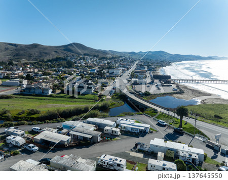 Aerial view of Cayucos, California USA, Pier, Ocean Ave and Shoreline Beach with Green Hills in San Luis Obispo County Aerial view of Cayucos, California USA, Pier, Ocean Ave and Shoreline Beach with Green Hills in San Luis Obispo County 137645550