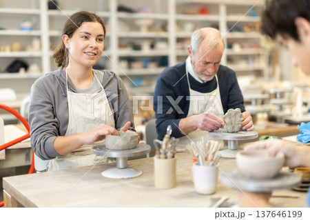 Young woman and man and elderly man crafting ceramics Young woman and man and elderly man crafting ceramics 137646199