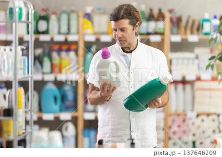 Man view trademark sign on label, pick eco friendly liquid detergent 137646209