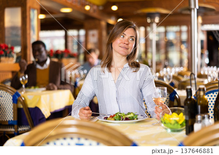 Portrait of woman enjoying delicious lunch in restaurant Portrait of woman enjoying delicious lunch in restaurant 137646881
