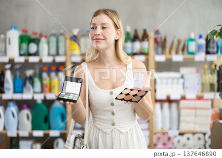 Interested young woman picking beauty products in store Interested young woman picking beauty products in store 137646890