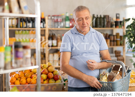 Mature man choosing something in grocery store 137647194