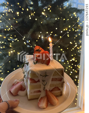 Strawberry cake with soft fluffy layers, topped with fresh strawberries and smooth cream, showcasing vibrant red fruit, delicate textures, and sweet inviting appearance in close-up detail 137647293