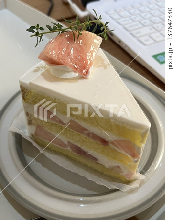 Strawberry cake with soft fluffy layers, topped with fresh strawberries and smooth cream, showcasing vibrant red fruit, delicate textures, and sweet inviting appearance in close-up detail Strawberry cake with soft fluffy layers, topped with fresh strawberries and smooth cream, showcasing vibrant red fruit, delicate textures, and sweet inviting appearance in close-up detail 137647330