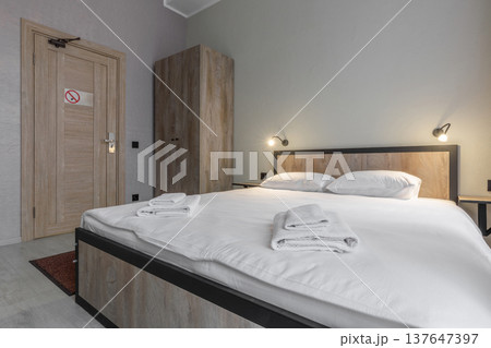 Double Bed in Minimalist Hotel Room with Wardrobe and Smart Lock Door Double Bed in Minimalist Hotel Room with Wardrobe and Smart Lock Door 137647397