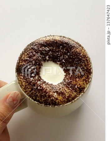 A beautifully crafted latte, featuring creamy foam art on top of rich espresso. Perfect for coffee-related projects, this image captures the warmth and inviting nature of a classic café experience. 137647423