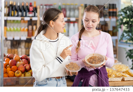 Young women choosing yakisoba in grocery store 137647433