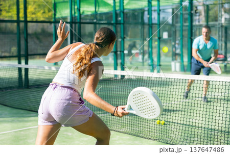 European woman tennis player in padel tennis playing on the outdoor court European woman tennis player in padel tennis playing on the outdoor court 137647486