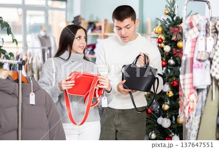 Couple in love choosing a handbag in a Christmas shop 137647551