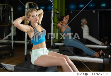 Woman doing bends on a reformer 137647688