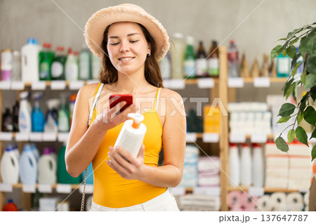 Young woman scanning qr code for sunscreen 137647787