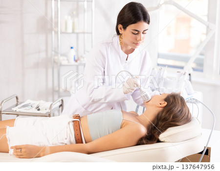 female doctor making facial beauty procedure with ice hummer 137647956
