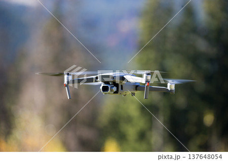 The drone copter flying with digital camera. The drone copter flying with digital camera. 137648054