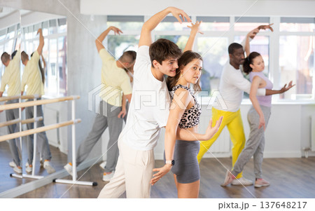 Man and young woman dancing waltz in couple during lesson at studio 137648217