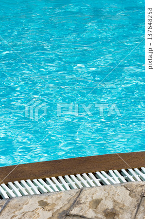 Blue pool water with sun reflections Blue pool water with sun reflections 137648258