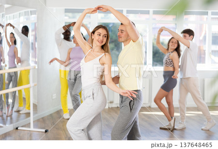 Young woman dances incendiary tango with man partner during choreography lesson 137648465