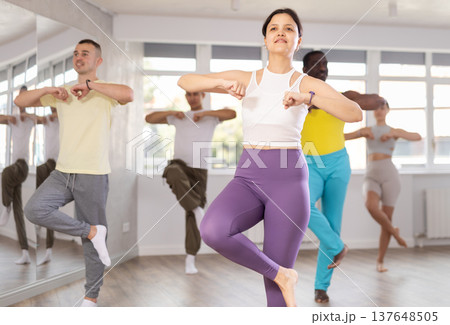 Young Asian woman practicing energetic dance at group class 137648505
