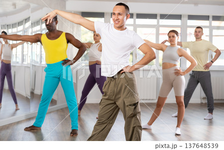 European guy with team of like-minded multinational people learn to elements of waacking dance 137648539