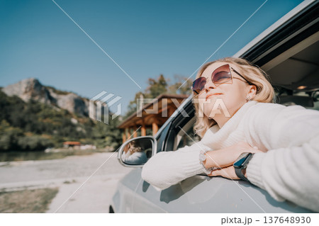 Woman in Sunglasses Enjoying a Road Trip Woman in Sunglasses Enjoying a Road Trip 137648930