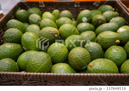 Fresh Green Avocados in Basket at Farmers Market Fresh Green Avocados in Basket at Farmers Market 137649519