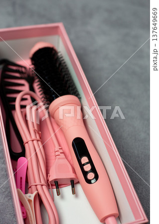 Professional pink electric multi styler for hair styling. Ceramic curling iron with comb and clips on neutral background. Salon-quality tool for perfect hairstyles at home Professional pink electric multi styler for hair styling. Ceramic curling iron with comb and clips on neutral background. Salon-quality tool for perfect hairstyles at home 137649669