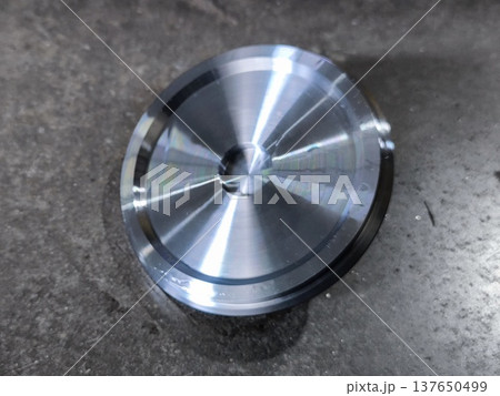 CNC Metal Cap parts on Concrete Floor 137650499