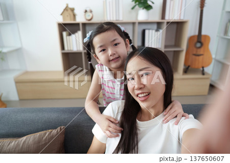 Mother and daughter sharing joyful moment at home 137650607