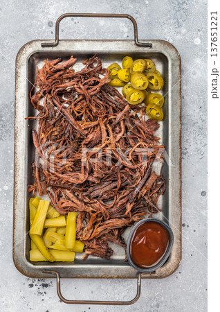 Smoked shredded brisket served with BBQ sauce and pickled vegetables, American barbecue food flat lay banner. Smoked shredded brisket served with BBQ sauce and pickled vegetables, American barbecue food flat lay banner. 137651221