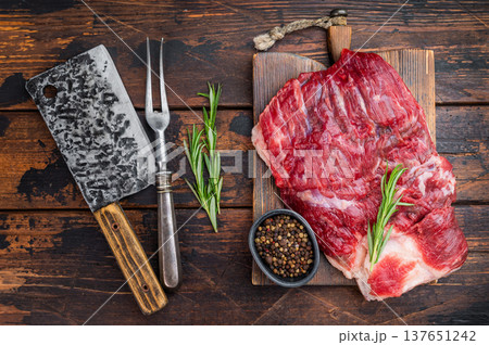 Raw beef brisket with cleaver on rustic wooden table, top view with copy space, fresh meat cut for barbecue and slow smoking Raw beef brisket with cleaver on rustic wooden table, top view with copy space, fresh meat cut for barbecue and slow smoking 137651242