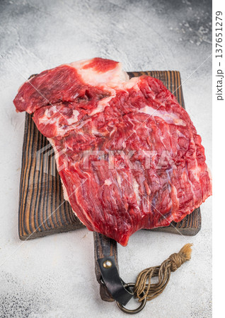 Raw beef brisket on wooden board with butcher tools, fresh uncooked meat cut ideal for barbecue, smoking and slow roasting Raw beef brisket on wooden board with butcher tools, fresh uncooked meat cut ideal for barbecue, smoking and slow roasting 137651279