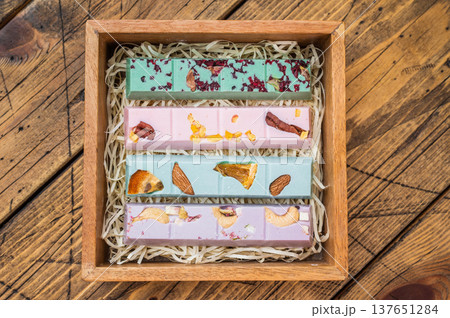 Gourmet colorful chocolate set in rustic wooden gift box with copy space handmade confectionery treat assortment Gourmet colorful chocolate set in rustic wooden gift box with copy space handmade confectionery treat assortment 137651284