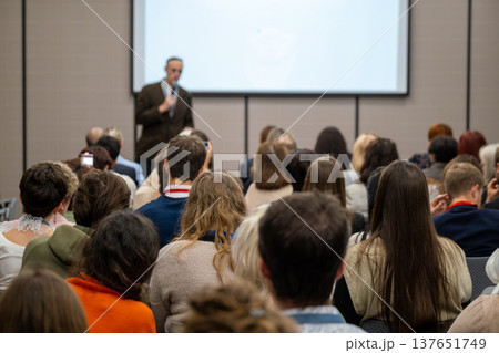 Audience listening to speaker during professional conference presentation in meeting room 137651749