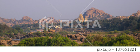 Distant view of the historic Virupaksha Temple, Hampi village, India. Distant view of the historic Virupaksha Temple, Hampi village, India. 137651821