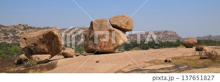 Unique shaped boulder popular for bouldering and distant view of the Hanuman Temple, Anjanadri Betta, Vijayanagara, in Hampi, India. Unique shaped boulder popular for bouldering and distant view of the Hanuman Temple, Anjanadri Betta, Vijayanagara, in Hampi, India. 137651827