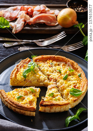 Quiche Lorraine with bacon, cheese and fresh basil 137653077