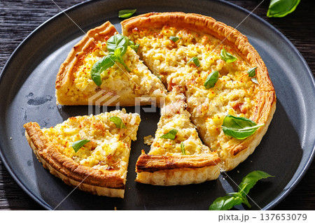 Quiche Lorraine with bacon, cheese and fresh basil 137653079
