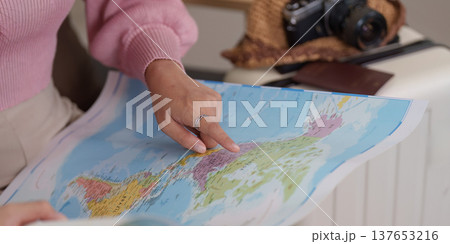 Exploring Destinations. Woman studying map for travel planning. Exploring Destinations. Woman studying map for travel planning. 137653216