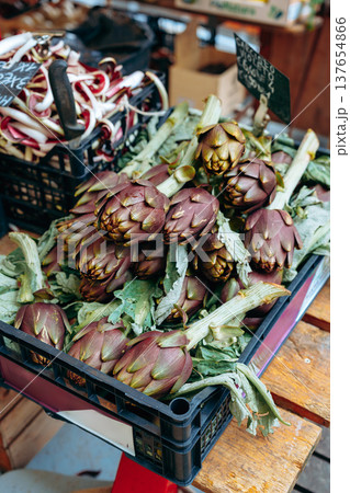 Market display with fresh artichokes in a local shop during daytime Market display with fresh artichokes in a local shop during daytime 137654866