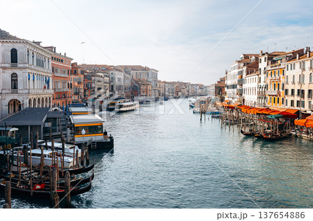 View of a Venetian canal with boats and buildings during daytime 137654886