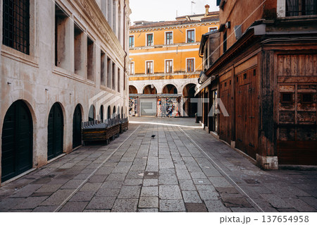 Street view in an old town with shops and empty benches in the morning light 137654958
