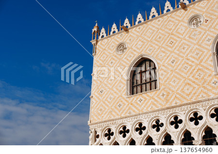 View of a historic building with ornate designs in a city under a clear sky View of a historic building with ornate designs in a city under a clear sky 137654960