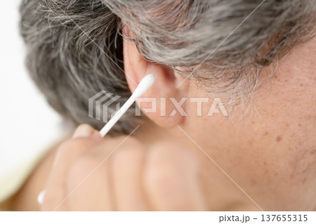 綿棒で耳掃除をするシニア女性 137655315