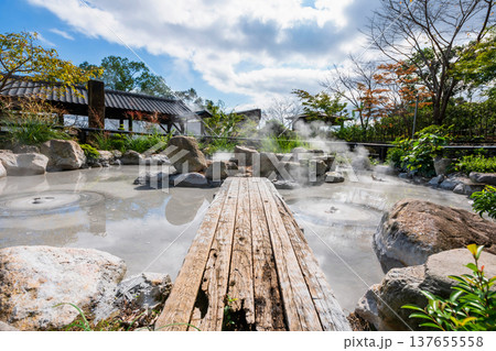 Oniishibozu Jigoku hot spring in fall garden against blue sky, Beppu Oniishibozu Jigoku hot spring in fall garden against blue sky, Beppu 137655558