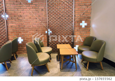 Cafe chairs and table by brick wall with plus holes Cafe chairs and table by brick wall with plus holes 137655562
