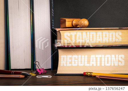 STANDARDS REGULATIONS Books Stack With Stamp Compliance Concept 137656247