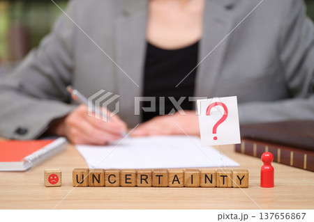 Navigating choices and uncertainty in a modern workspace filled with questions and contemplation 137656867