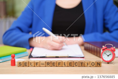 Self-reflection through writing and planning in a cozy workspace with a vintage clock and personal touches 137656885