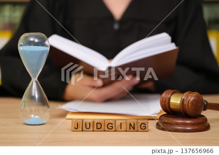 Creating fair outcomes in court as a judge reviews evidence, balances time, and contemplates justice in a serious setting Creating fair outcomes in court as a judge reviews evidence, balances time, and contemplates justice in a serious setting 137656966