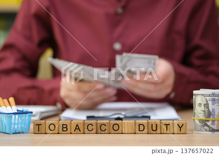 Managing tobacco duty and finances in a busy office during the late afternoon hours 137657022